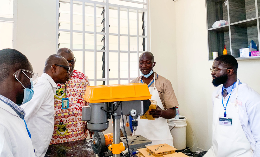 Mr Eric Kwesi Koomson explaining to the SMS Dean how the machine works